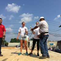 <p>Volunteers get to work before Habitat for Humanity of Coastal Fairfield County holds a wall raising for Bridgeport&#x27;s Pope Francis House on Wednesday.</p>