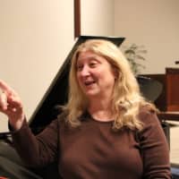 <p>Marlane Tubridy gestures to members of Cantiamo choir. She will direct the choir in a Christmas concert at Westport Town Hall Friday, Dec. 9, 2016.</p>
