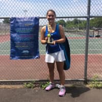 <p>A girl displays her trophy that she won at a recent Slammer Tennis World tournament, which was held at Norwalk High School.</p>