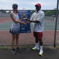 <p>Marvin Tyler of Slammer Tennis World, right, awards a trophy to one of the tournament participants.</p>