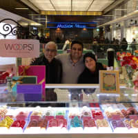 <p>L to R: franchisee Peter Chandnani, majority investor Raj Bhatt, and Woops! employee Shay at a Woops! kiosk in Port Authority.</p>