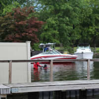 <p>Mahopac Falls Volunteer Fire Department Dive Team members enter the water to begin their search in Lake Mahopac on Monday, July 22.</p>