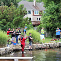 <p>Divers, dive tenders, EMT and ambulance crew and Incident Command Chief Brian Sacher of the Mahopac Falls Volunteer Fire Department near the area where the body was recovered.</p>