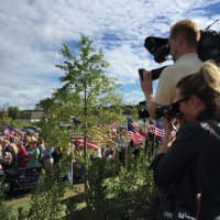 <p>News crews film the bagpipe procession at Greenwich&#x27;s 9/11 Memorial dedication Friday morning. </p>
