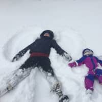 <p>A mother and her toddler enjoy making snow angels in Poughkeepsie.</p>