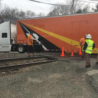 <p>Officials on the scene of a truck stuck on the tacks near the West Redding train station.</p>