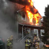 <p>The second floor at 47 Pickens Street was fully engulfed as emergency workers arrived for the 8 a.m. call.</p>