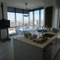 <p>A kitchen and dining room in a two-bedroom apartment at &quot;The Modern.&quot;</p>