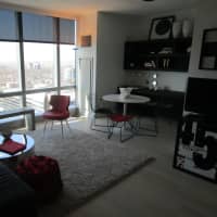 <p>The living room in a three-bedroom apartment at &quot;The Modern.&quot;</p>