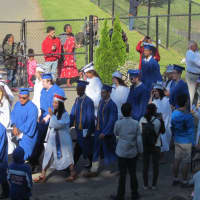 <p>The students make their way to the football field for the Danbury High graduation on a sunny Thursday.</p>