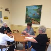 <p>Friends play a hand of cards at the Trumbull Senior Center.</p>