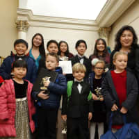 <p>Piano teacher Felicia Zhang and some of her piano students from Fairfield County after their performance at Carnegie Hall.</p>