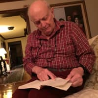 <p>John Grande of Teaneck, 84, reads a chapter from his book, &quot;Scorekeeper at the Met.&quot;</p>