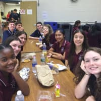 <p>Freshmen and upperclassmen eat lunch together on the first full day of school at Burke Catholic High School.</p>