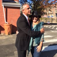 <p>GOP mayoral hopeful Enrique Torres hugs a fan on Election Day outside Black Rock School.</p>