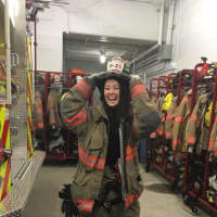 <p>Erin, an au pair from Sweden, gets a laugh out of trying on gear at the South Salem Firehouse.</p>