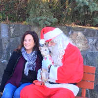 <p>Renee Makras and her 16-year-old dog, Lucy came out to visit with Santa at Mike Risko Music on Sunday. </p>