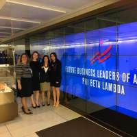 <p>Mamaroneck High School students rang the closing bell at the New York Stock Exchange on Friday, Jan. 13. From left are: adviser Maria Siciliano, FBLA co-president Marie Amelie Morang, senior Sophia Danziger and FBLA co-president Lauren Pogostin.</p>