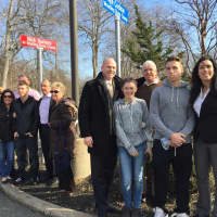 <p>The Surianos, left, and the Cochrans, right stand under the new signs outside of borough hall in Paramus honoring NJSIAA state wrestling champions Nick Suriano and Kyle Cochran.</p>