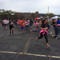 <p>Bryan Ripley Crandall (center, orange shirt) nears the finish line in the 2015 Vicki Soto 5K.</p>