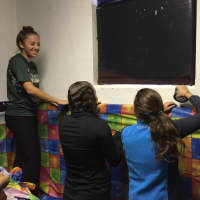 <p>Norwalk resident Grace Godeski -- and other members of the church&#x27;s youth group -- cover prepare the old carriage house of the St. Philip Church Monday for the church&#x27;s annual haunted house.</p>