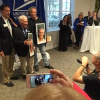 <p>Media take photos of officials celebrating the Paul Newman stamp -- released earlier this year -- at an event Wednesday evening in Westport.</p>