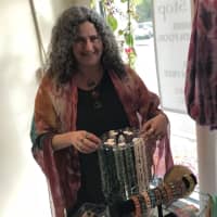 <p>Karen Lauber shows off some items offered at her Wyckoff store.</p>