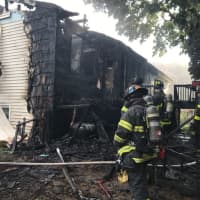 <p>Firefighters knock down a blaze at a home that was reportedly caused by a lightning strike, according to the Norwalk Fire Department.</p>