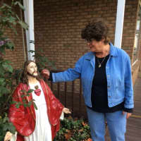 <p>Midge Saglimbene and her Jesus statue outside Angels &amp; Company in Monroe.</p>