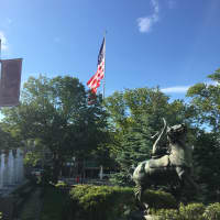 <p>A view of the new flag from the steps of the Danbury Public Library with the statue of Sybil Ludington in the foreground.</p>