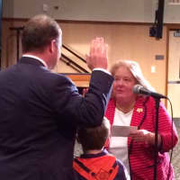 <p>Former State Rep. Cathy Tymniak swears in her son, Christopher, as Selectman.</p>