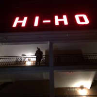 <p>A photographer takes a photo of the crowd cheering as the Hi-Ho sign is lit again Tuesday night.</p>