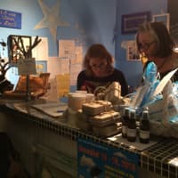 <p>Volunteers help customers check out at All is Well non-profit boutique in Wyckoff Thursday, Dec. 10.</p>