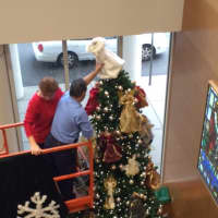 <p>Connie Gabriel, St. Vincent&#x27;s Medical Center employee of the year, adds an angel to the top of the hospital&#x27;s Christmas tree.</p>