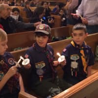 <p>Hasbrouck Heights Cub Scouts pass the flame of the Peace Light Friday night, Dec. 18.</p>