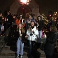 <p>Carolers sing outside Corpus Christi Church in Hasbrouck Heights Friday night.</p>