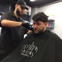 <p>Sal Polisi of Fair Lawn says barber Izak Orero of Garfield is the only one he trusts to cut his hair.</p>
