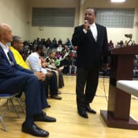 <p>Teaneck Board of Education President Dr. Ardie Walser speaks to longtime basketball coach Curtis March at a court-naming ceremony Thursday, Jan. 7 at Teaneck High School.</p>