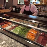 <p>A chef prepares sushi at Soosh in Stamford.</p>