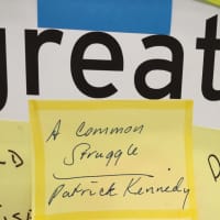 <p>Readers have written the names of their favorite books on sticky notes, which are posted on a window on the Darien Library&#x27;s first floor. </p>