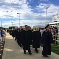 <p>Superintendent Colleen Palmer leads the processional at the Weston High graduation on Monday.</p>