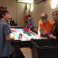 <p>Ringwood teacher Ellen Gay, at right, helps her students set up their Lego robotics display at the library Thursday, Jan. 14.</p>