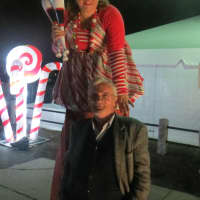 <p>Brenn Swanson, the Westchester County parks worker on stilts, stoops down to direct Preng Menga of the Bronx to various attractions at Winter Wonderland at Kensico Dam Plaza on Saturday. The fest resumes Thursday thru Dec. 23 &amp; Dec. 26 thru Jan. 3.</p>