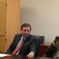 <p>U.S. Sen. Christopher Murphy, left, listens to residents at a Bridgeport roundtable on energy assistance, as Charles Tisdale, executive director of Action for Bridgeport Community Development, looks on.</p>
