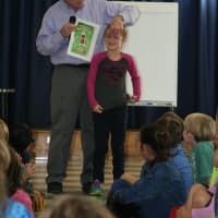 <p>First-grader Michaela O&#x27;Brien and author David Adler</p>