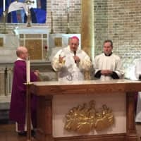 <p>Bishop Nicholas DeMarzio consecrates the altar at The Shrine Church of Our Lady of Solace in Coney Island. The church was badly damaged by Superstorm Sandy in 2012.</p>