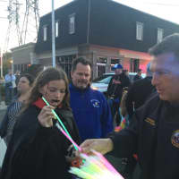 <p>Bergen County Freeholder Steve Tanelli hands out glow sticks.</p>