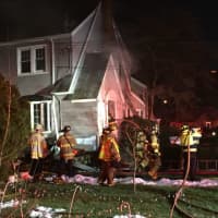 <p>Stamford firefighters tackle the blaze in a home at 26 Underhill St. on Wednesday afternoon.</p>