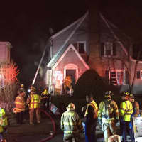 <p>Stamford firefighters tackle the blaze in a home at 26 Underhill St. on Wednesday afternoon.</p>
