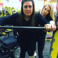 <p>Lauren LaPorta of Bergenfield steadies herself on the bar and prepares to squat. Her trainer, Erica Little, supports her at Retro Fitness of Hackensack.</p>